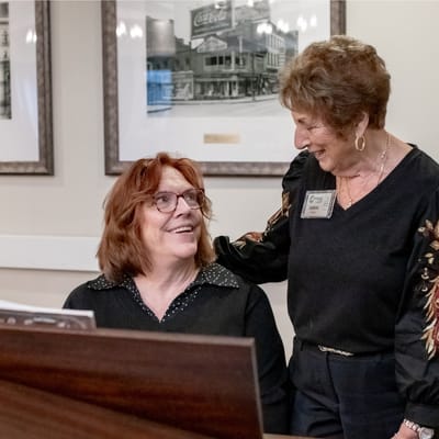 Two residents smiling in a warm common area