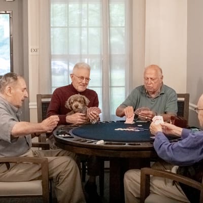 Residents playing poker in a common area