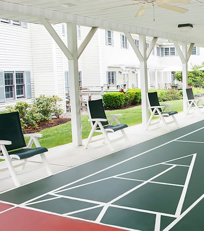 Outdoor seating area with games and greenery