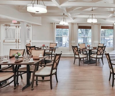 Dining area with tables and chairs set for a meal