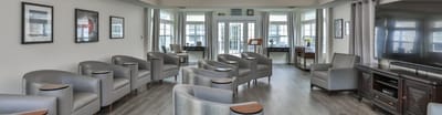 Stylish common area with grey chairs and large windows