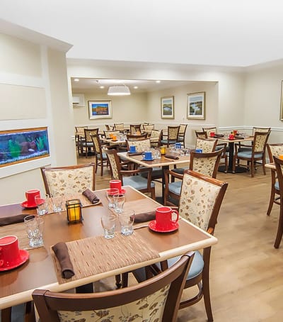 Dining area with tables set for residents