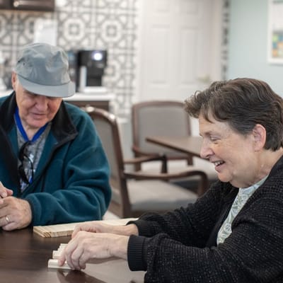 Two residents playing a game together indoors