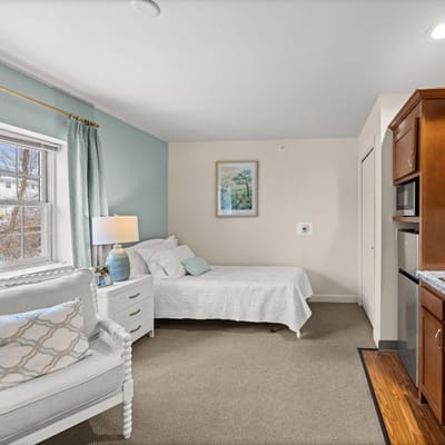 Interior view of a cozy resident room with a bed and a chair
