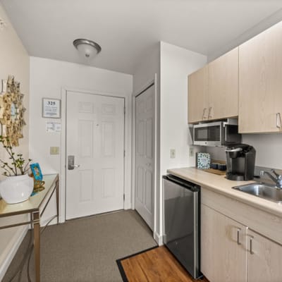 Interior view of a resident's room with kitchen area