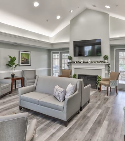 Bright interior common area with seating and a TV