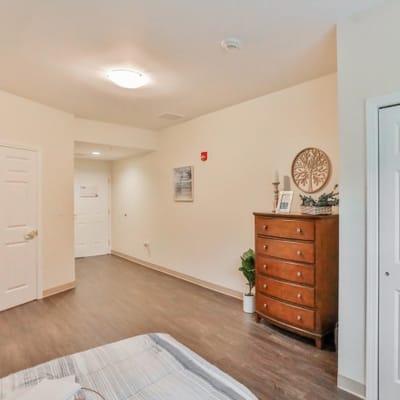 Cozy resident room with a dresser and artwork