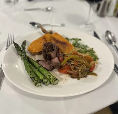 Plated meal with beef, sweet potato, and asparagus