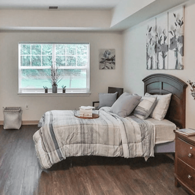 A private resident room with a bed and decor