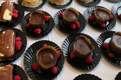 Desserts plated with raspberries on a table