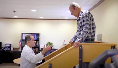 Therapist assisting a resident on a therapy staircase