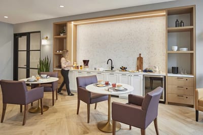 Bright dining area with food served and staff present