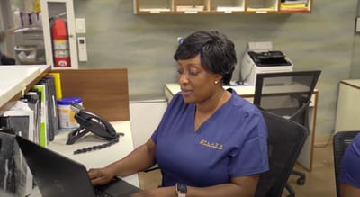 Staff member working at a computer in an office setting