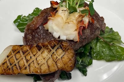 Gourmet meal featuring steak and seafood