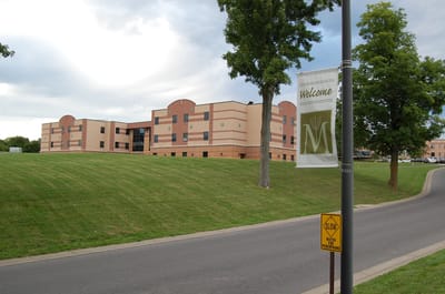 Exterior view of the assisted living facility with welcome banner