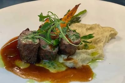 Artfully plated meal with vegetables and sauce