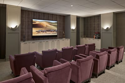 Cozy movie theater with plush seating and a large screen