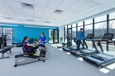 Residents exercising in a modern fitness room