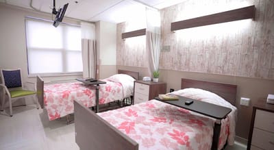 A comfortable resident room with two beds and decor