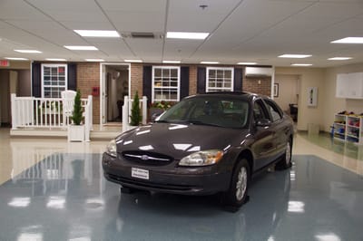 A car parked in a facility interior space