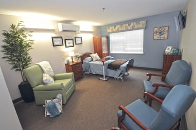 Cozy resident room with two beds and seating area