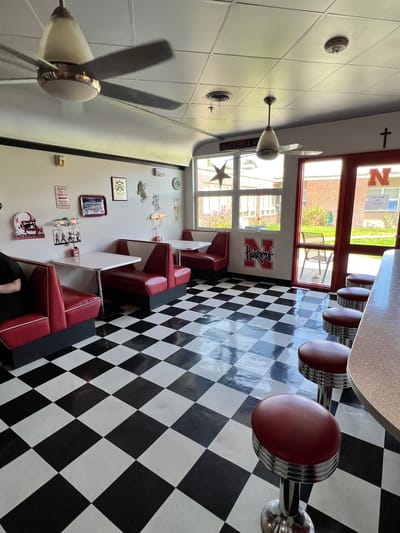 Dining area with red booths and checkered floor