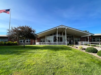 Exterior view of Mt Carmel Home with landscaped lawn