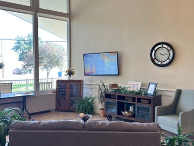 Bright interior common area with plants and a clock