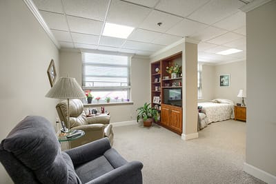 Cozy resident room with a bed and seating area