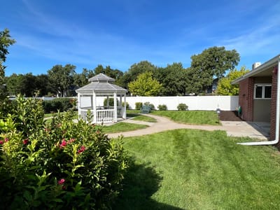 Outdoor patio with gazebo and well-maintained green space