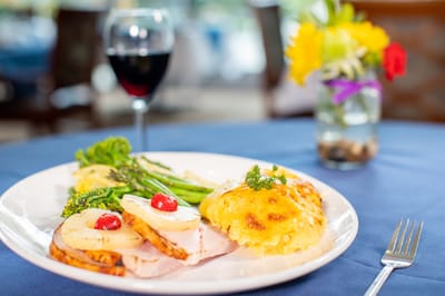 A well-presented meal with wine in a dining room
