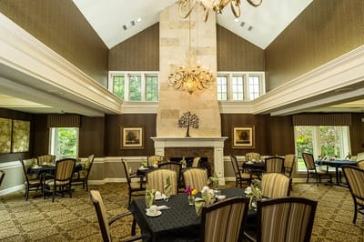 Elegant dining room with chandelier and tables set for meals