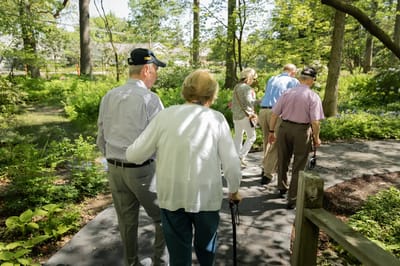 Group of residents walking in a garden pathway