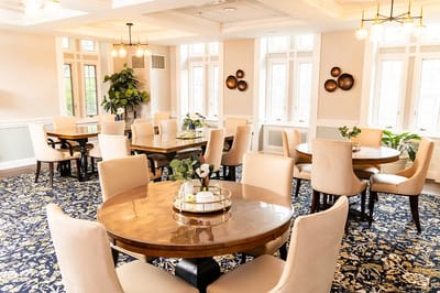 Bright dining room with well-set tables and chairs