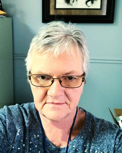 Self-portrait of a staff member with short gray hair.