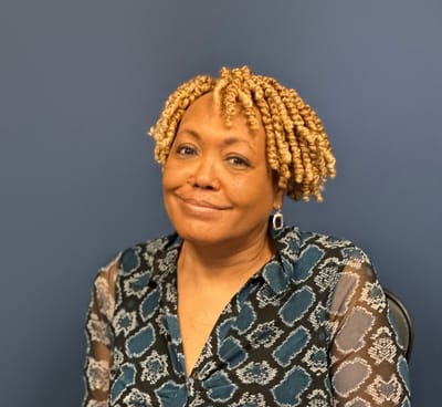 Staff member smiling in a professional setting.