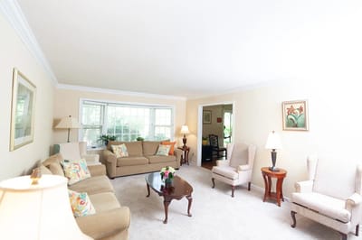 Cozy common area with sofas and lamps.