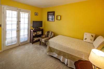 Cozy bedroom with yellow walls and a bed