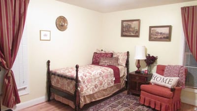 Cozy bedroom with floral bedding and warm decor.
