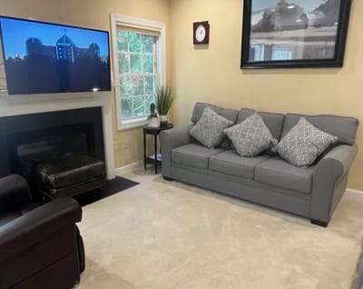 Cozy common area with sofa and TV.