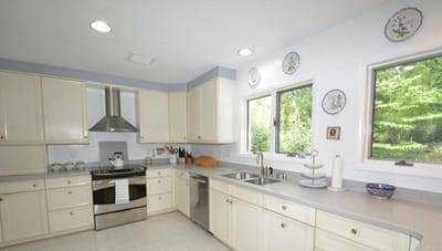 Bright, modern kitchen with white cabinetry and natural light.