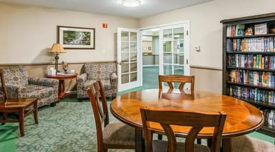 Cozy common area with seating and bookshelves.