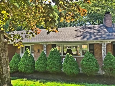 Exterior view of a facility building with greenery.