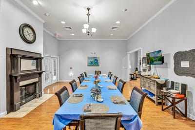 Dining area with a long table set for a meal.