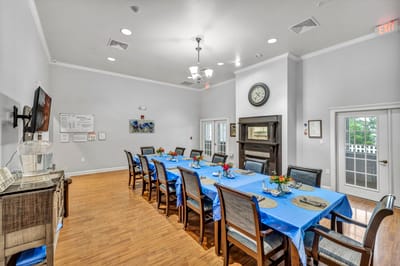 Dining room set for a meal with blue tablecloths.
