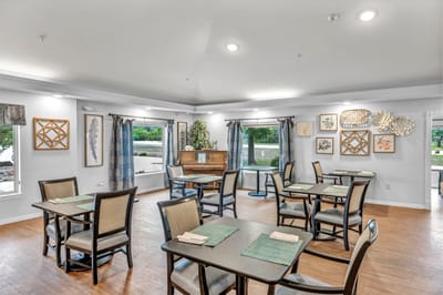 Dining area with tables and artwork on the walls.