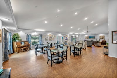 Dining area with tables and artwork on the walls.
