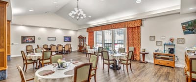 Dining area with tables and chairs set up.