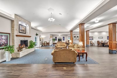 Interior view of a cozy common area with seating and artwork.