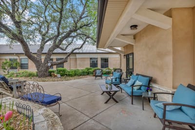 Outdoor patio seating area with blue chairs